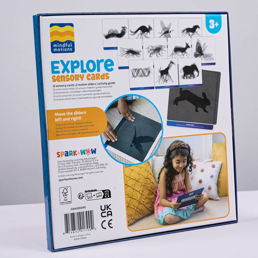 The retail packaging box for 'Explore Sensory Cards' by Mindful Motions and SparkWow, featuring a white background with blue borders, product illustrations, and a lifestyle photo of a child playing with the cards.