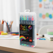 Set of brush markers in a clear plastic case on a desk with colorful background