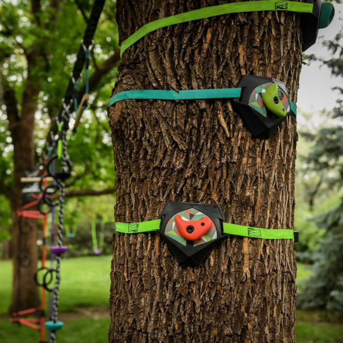 Tree stand with green straps and camouflage design attached to a tree in a forest setting.