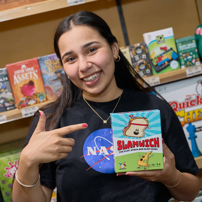 Woman holding a 'Slamwich' game box in a store setting
