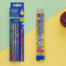 Colorful pencils with cartoon designs on a yellow and green background