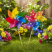 Two colorful pinwheels on sticks against a white background
