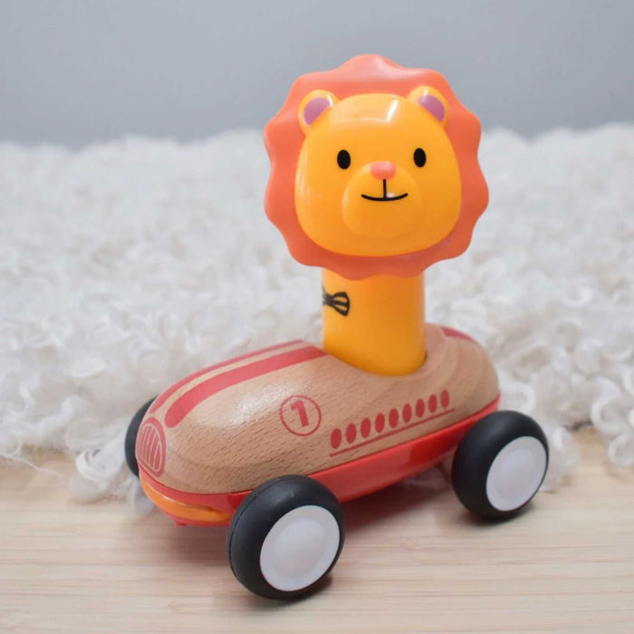Toy car with lion design on top, featuring a wooden body and black wheels, on a soft white background.