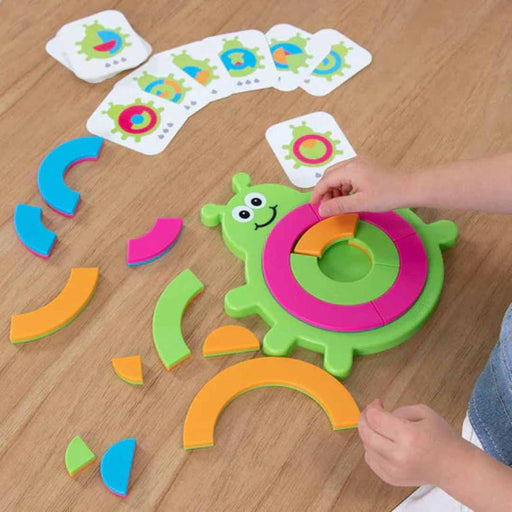 Colorful children's educational toy on a wooden surface with cards in the background
