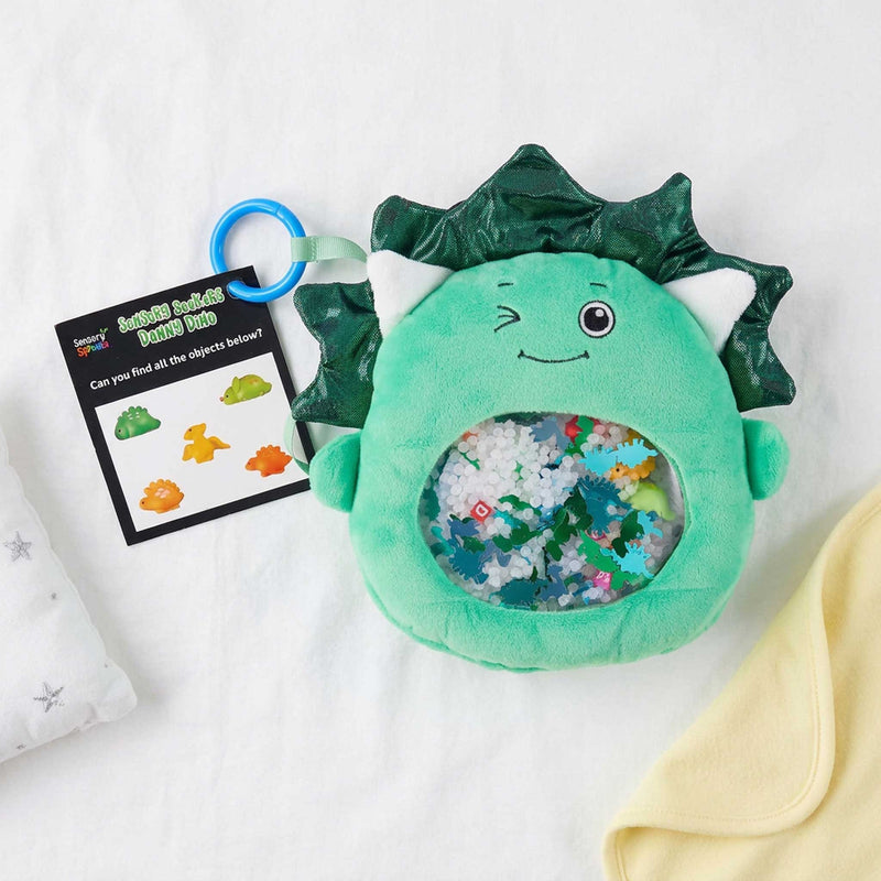Sensory Seekers Danny Dino tactile exploration toy on a babe bed