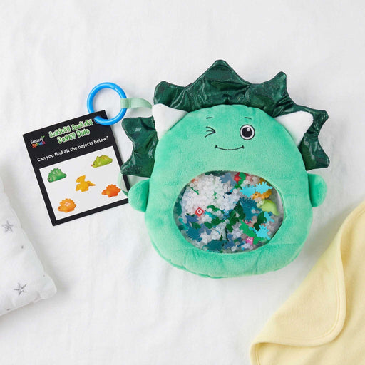 Sensory Seekers Danny Dino tactile exploration toy on a babe bed