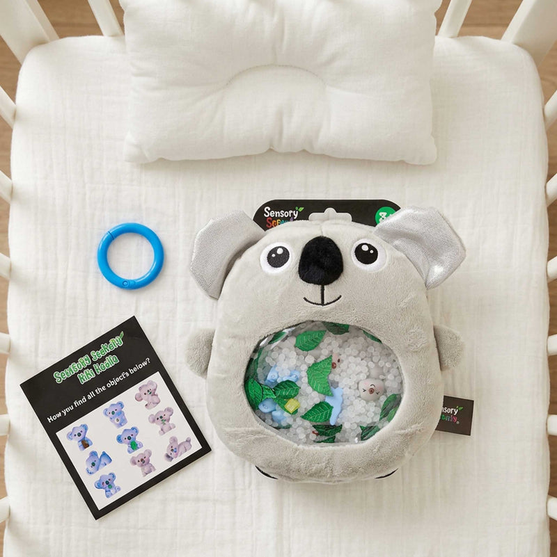 Sensory Seekers Kiki Koala is a tactile on a baby bed