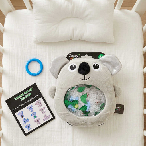 Sensory Seekers Kiki Koala is a tactile on a baby bed