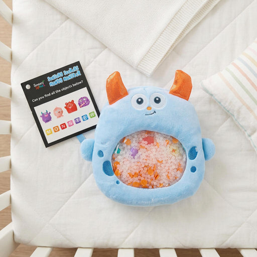 Monty Monster is a tactile wonder baby toy on a baby bed