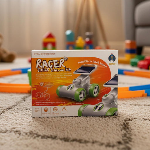 A boxed STEM experiment kit labeled 'Racer Solar Science Kit' standing on a beige carpet in a living room. The box shows a solar-powered toy racer with gray body and green wheels, and the brand name 'SOLILY' is visible on the top right.