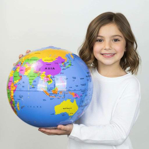 A young girl with brown hair wearing a white long-sleeve shirt holds a colorful world map globe against a plain light gray background.